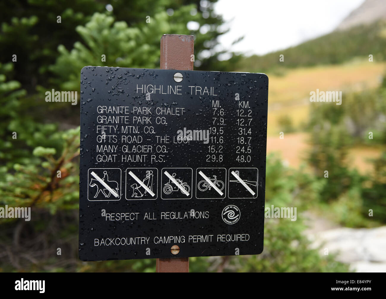 National Park Service sign with mileage and rules at the start of the Highline Trail in Glacier National Park, Montana. Stock Photo