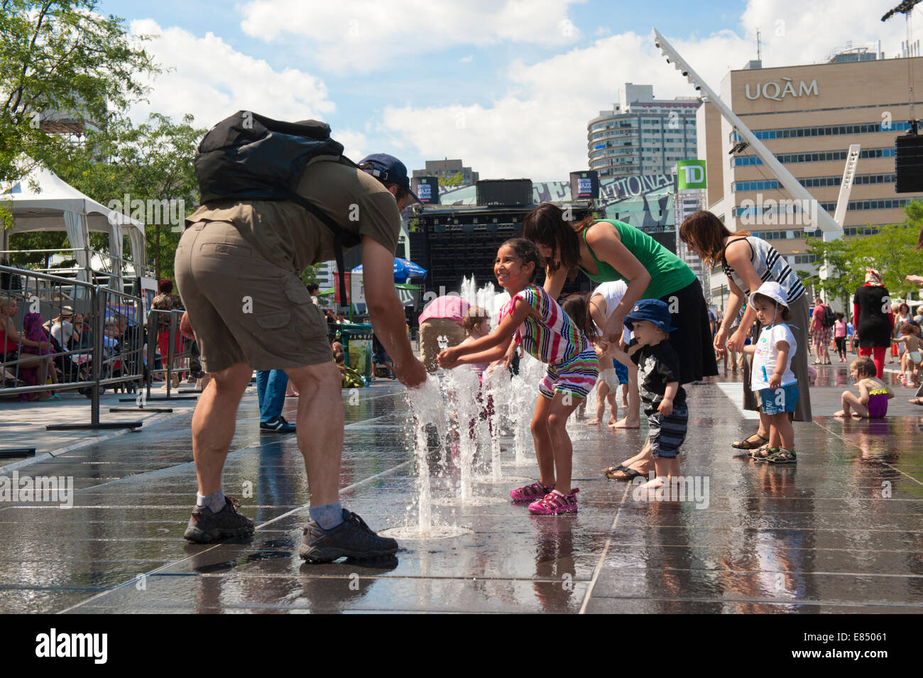 Parents and children enjoying the fountains on Place des Festivals, Montreal, province of Quebec, Canada. Stock Photo