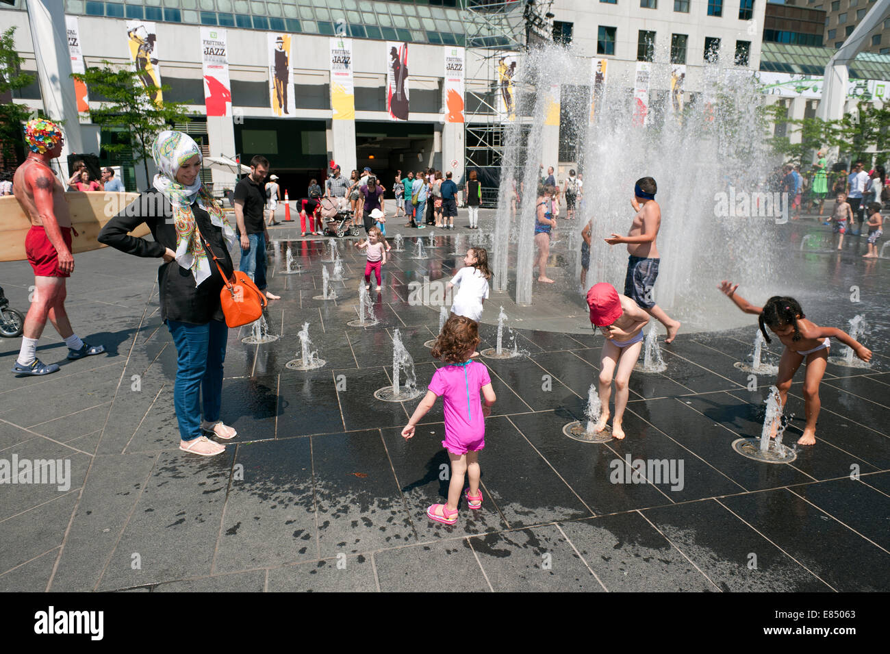 Children enjoying the fountains on Place des Festivals, Montreal, province of Quebec, Canada. Stock Photo