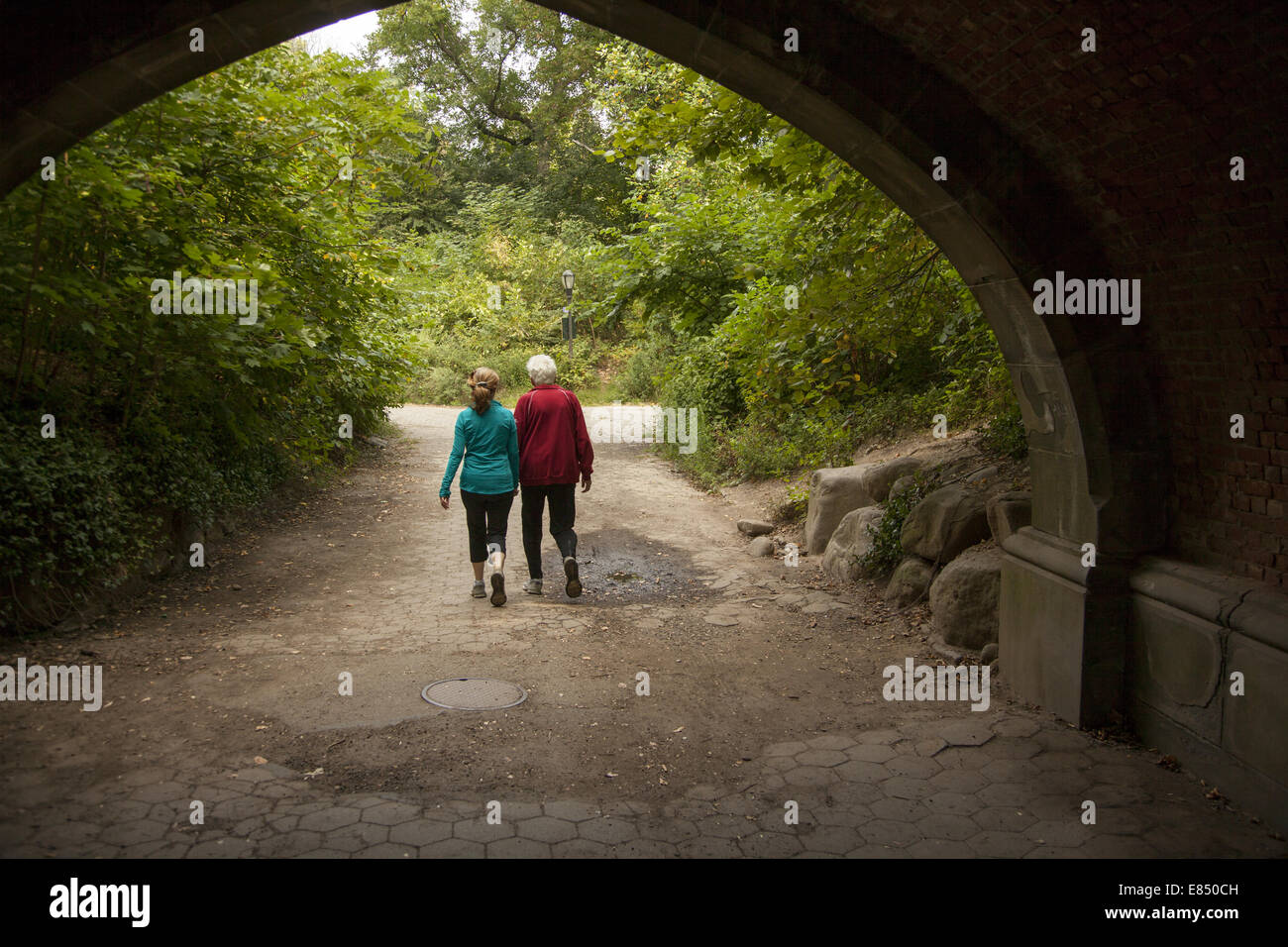 Older couple walk hand in hand in Prospect Park, Brooklyn, NY. Stock Photo