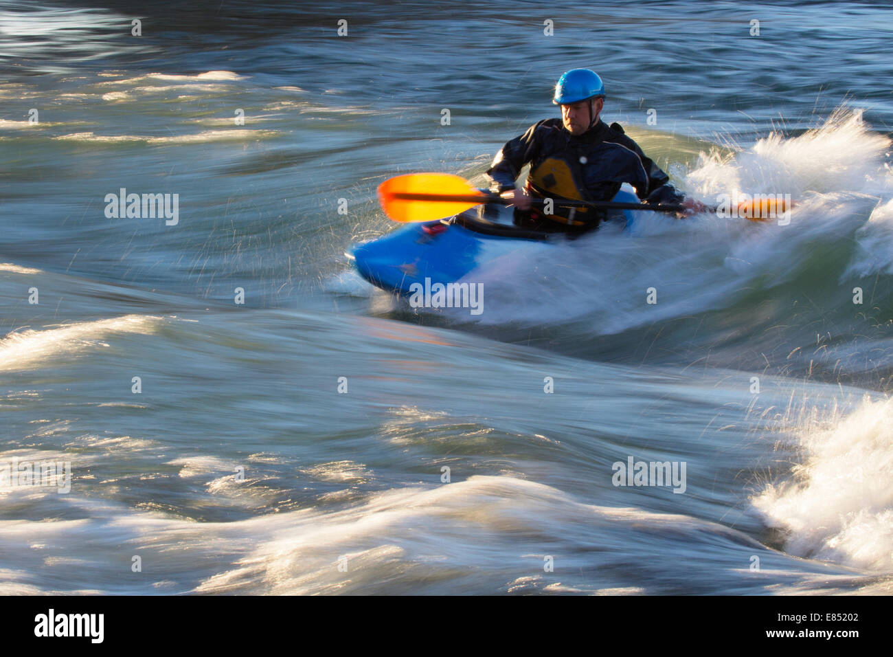 Kayaker on the Bow River in downtown Calgary. The stationary wave was