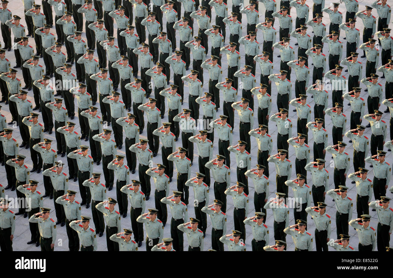 Nanjing. 1st Oct, 2014. Armed policemen salute in a flag-raising ceremony marking the 65th anniversary of the founding of the People's Republic of China in Nanjing, capital of east China's Jiangsu Province, Oct. 1, 2014, also the Chinese National Day. Credit:  Li Ke/Xinhua/Alamy Live News Stock Photo