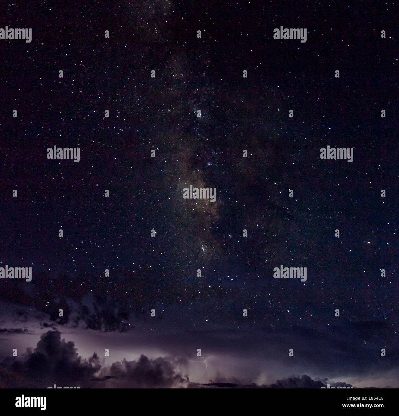 Milky Way and stars above thunderstorm and lightning at the horizon in Big Bend National Park. Stock Photo