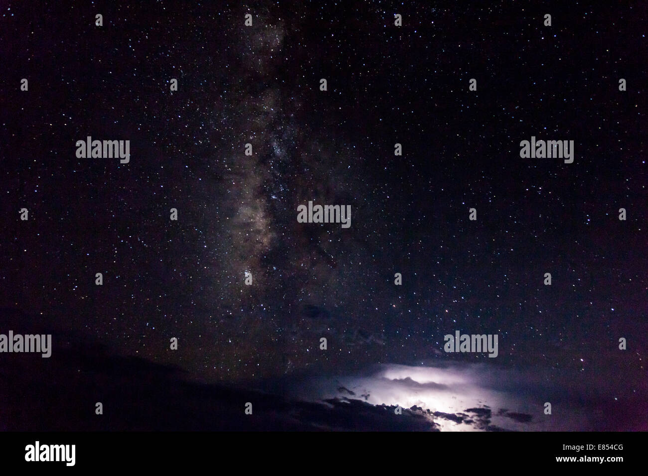 Milky Way and stars above thunderstorm and lightning at the horizon in Big Bend National Park. Stock Photo