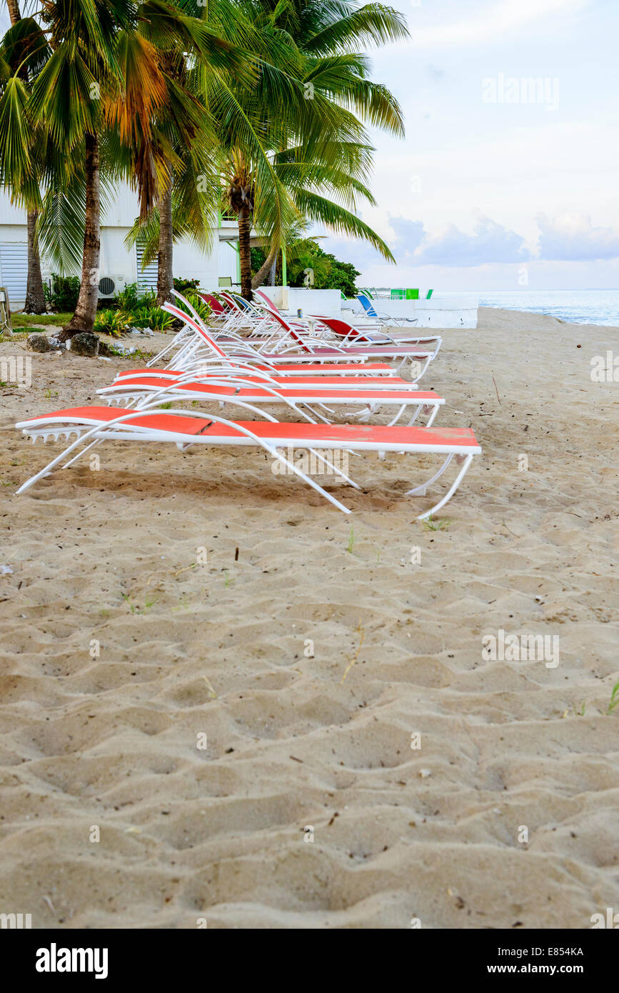 Beach chairs line up on the beach, west end, of St. Croix, U.S. Virgin Islands at dawn. Stock Photo