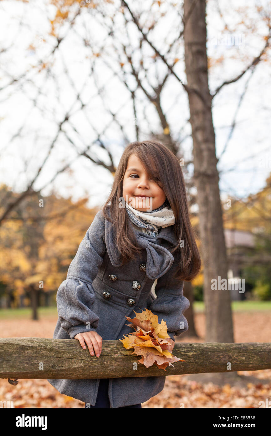Little girl with autumn leaves in an autumn park Stock Photo - Alamy