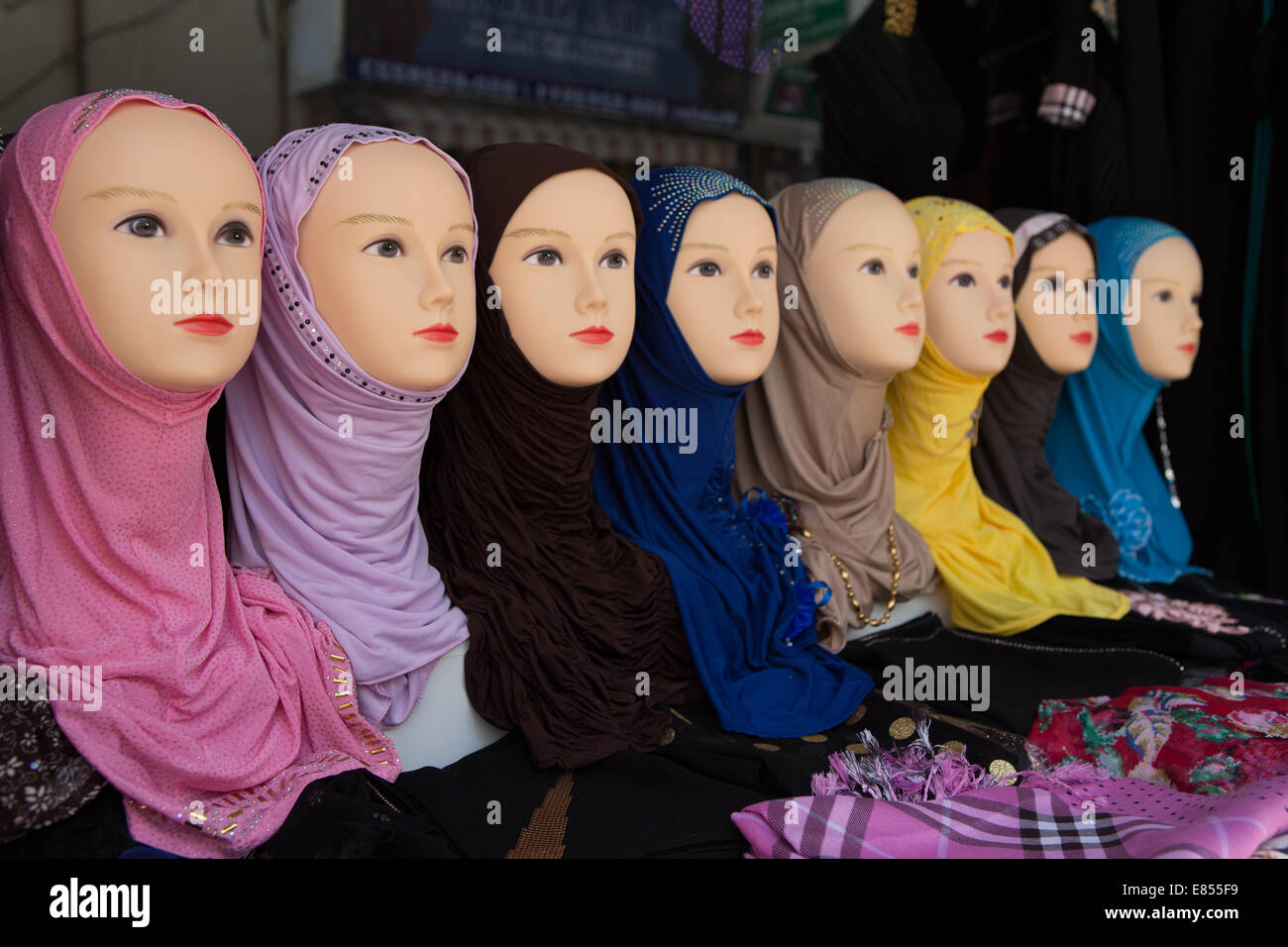 Mannequin's display colorful AlAmira veils for sale in a Deira market