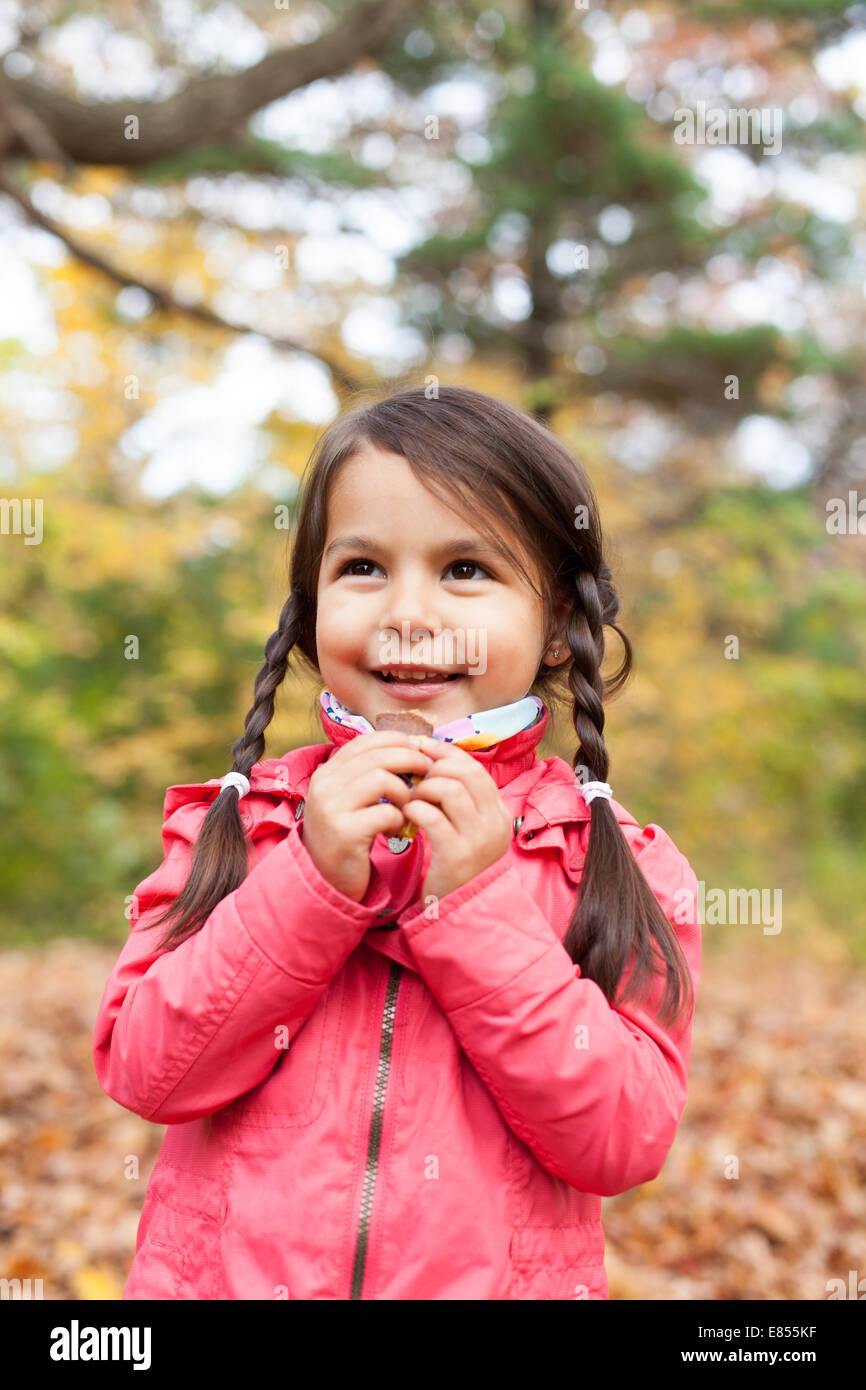 Little girl with autumn leaves in an autumn park Stock Photo - Alamy
