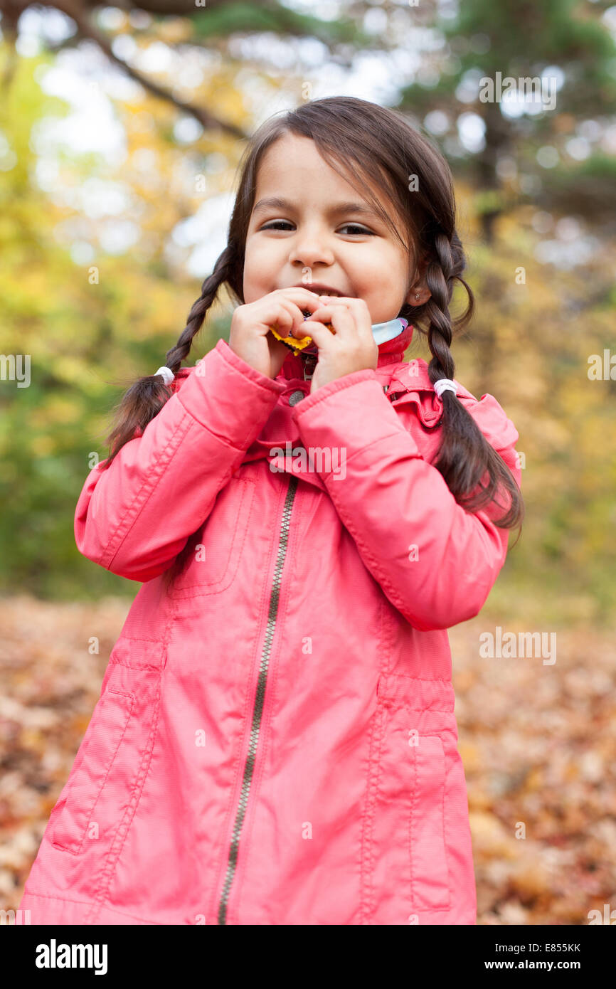 Little girl with autumn leaves in an autumn park Stock Photo - Alamy