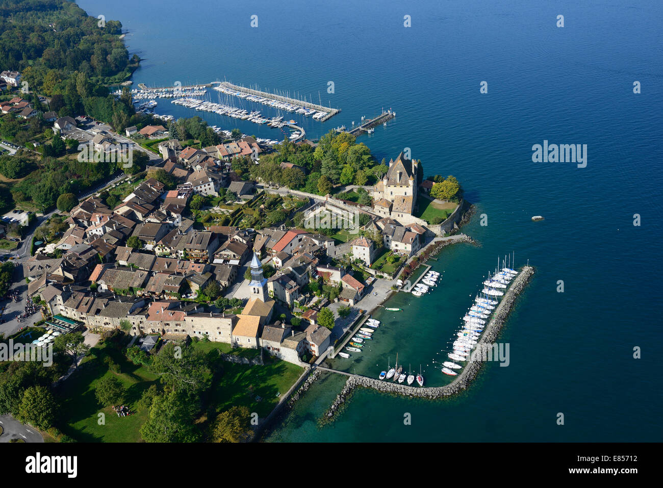AERIAL VIEW. Picturesque medieval village on the lakeshore of Lake Geneva. Yvoire, Haute-Savoie, Auvergne-Rhône-Alpes, France. Stock Photo