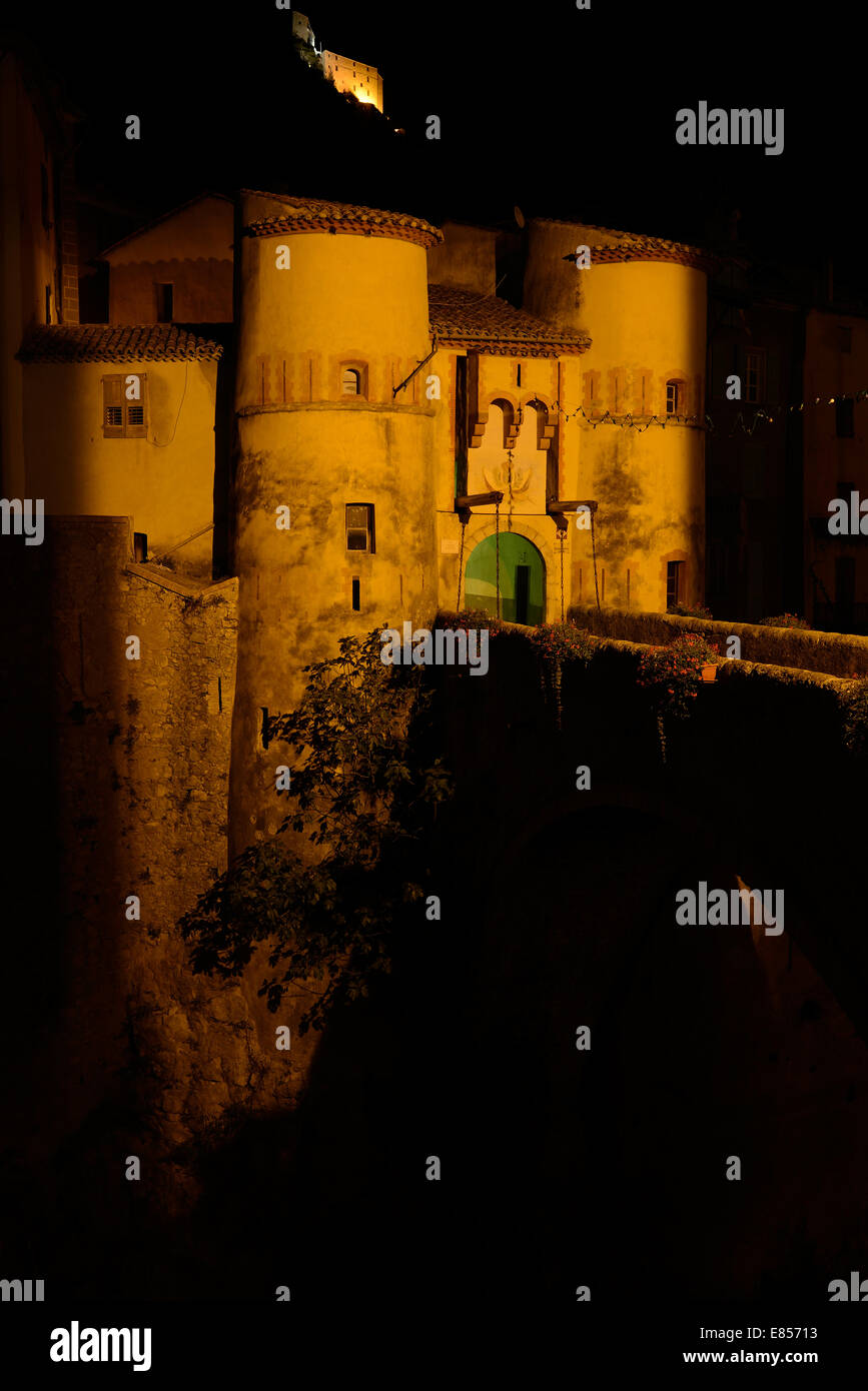 Access bridge to a medieval village at night. Entrevaux, Alpes-de-Haute-Provence, France. Stock Photo