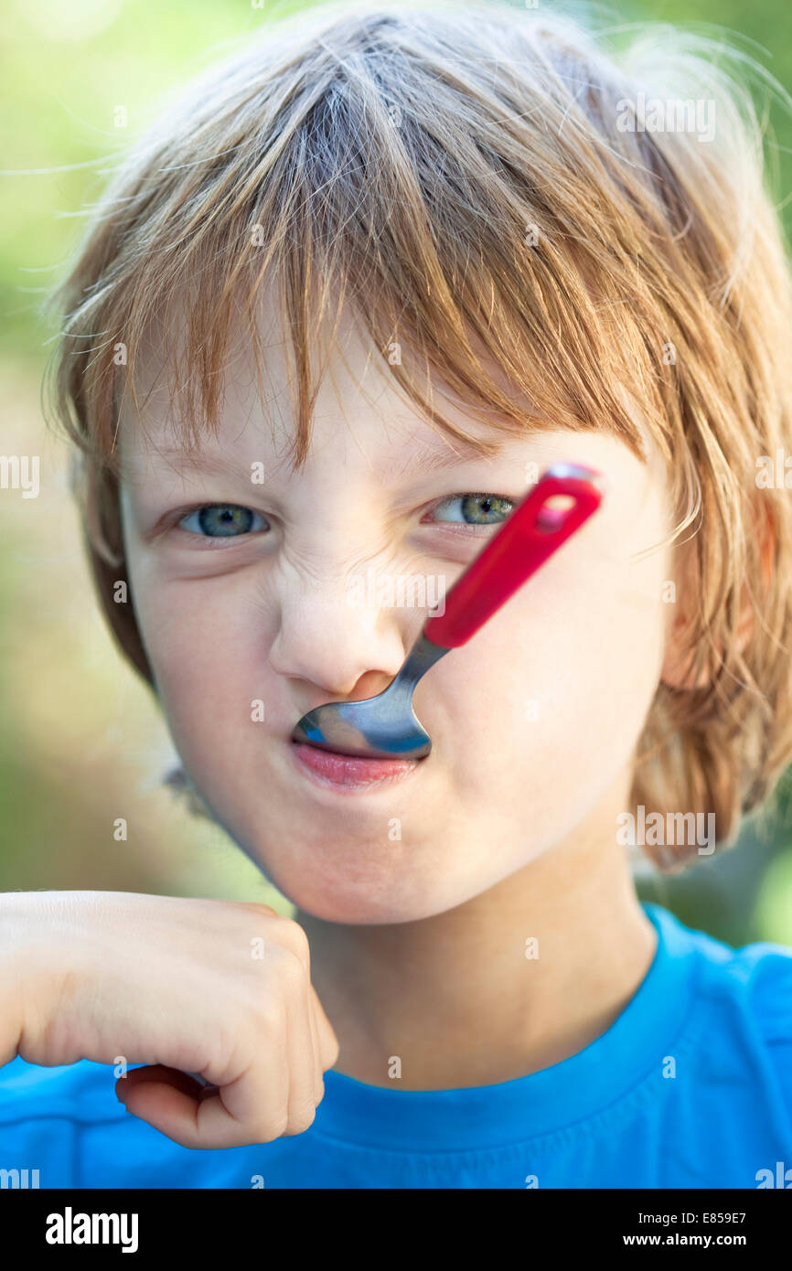 Boy Eating, Fooling Around with Fork Stock Photo