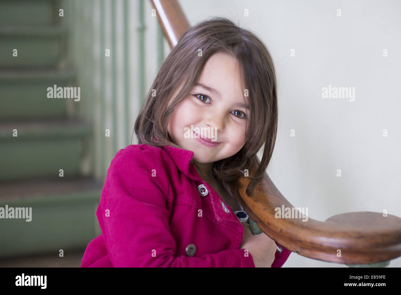 Little girl leaning against bannister, portrait Stock Photo