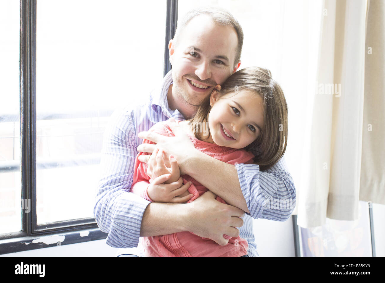 Father embracing young daughter, portrait Stock Photo