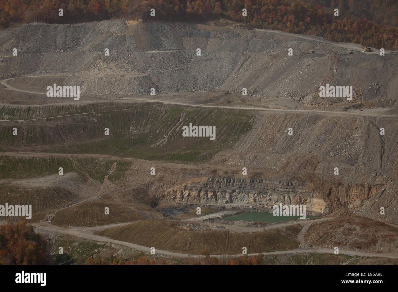 Excavated mountaintop coal mine with slag heaps and pit lake