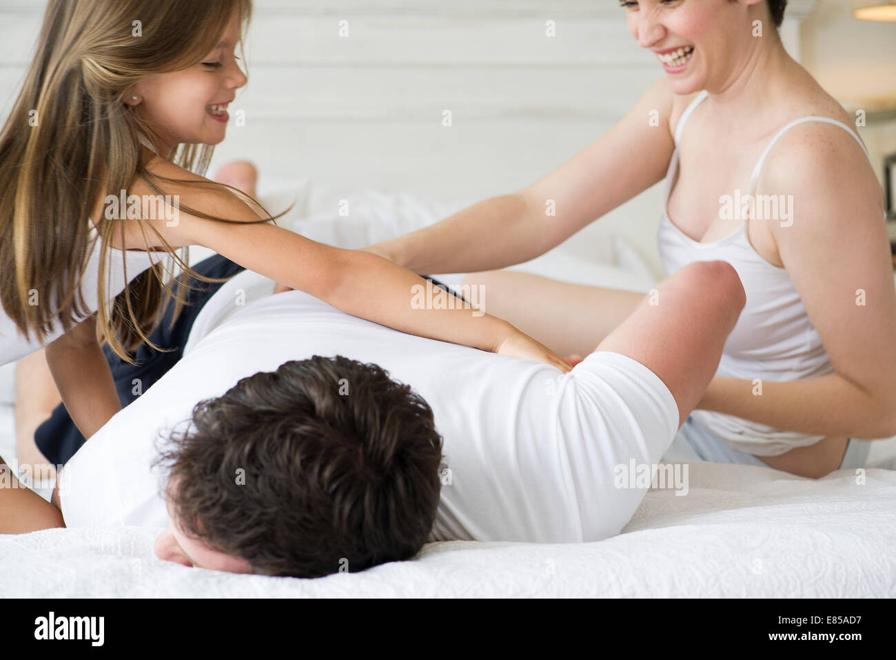 Family playing on bed Stock Photo