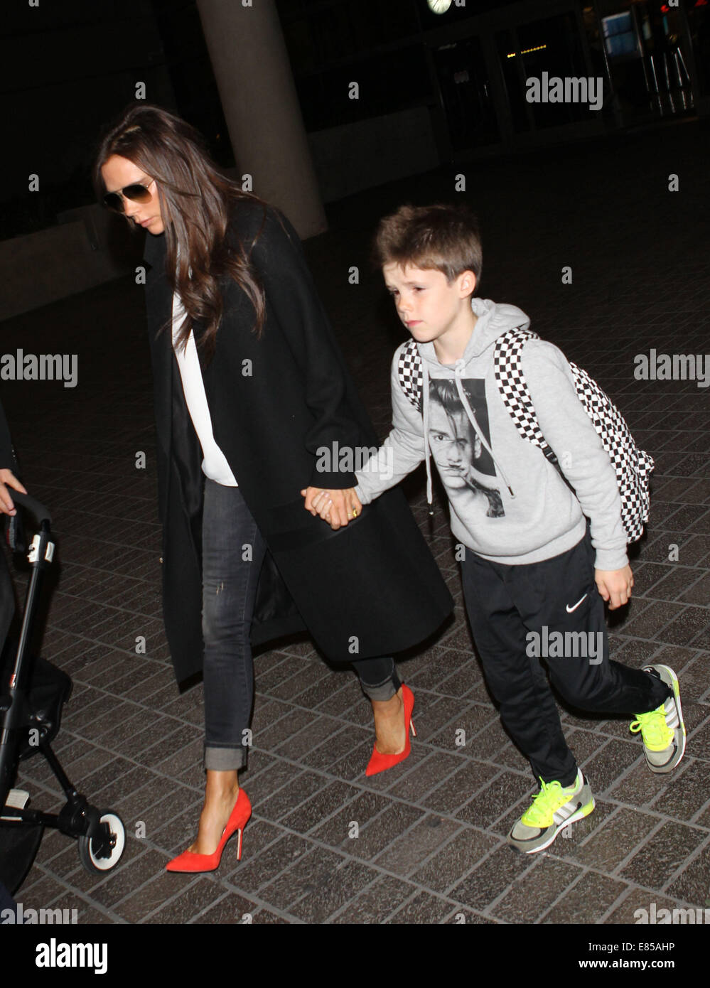 Victoria Beckham with her children at Los Angeles International Airport (LAX)  Featuring: Victoria Beckham,Cruz Beckham Where: Los Angeles, California, United States When: 29 Mar 2014 Stock Photo