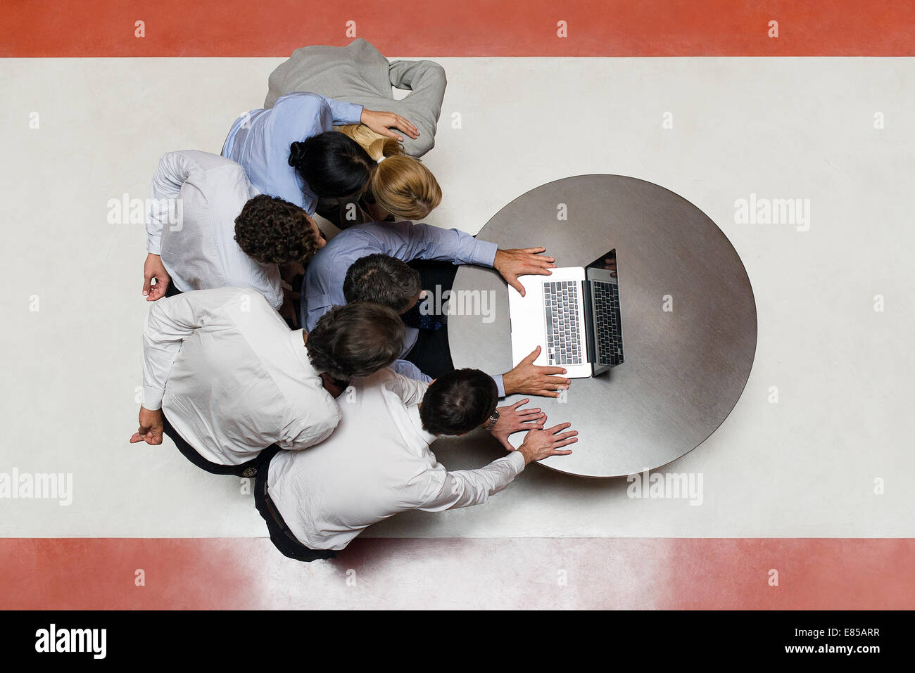 Business associates staring at laptop computer in disbelief Stock Photo