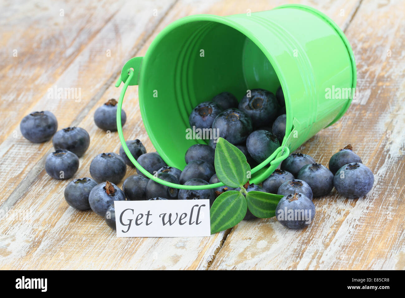 Get well card with blueberries scattered on wooden surface Stock Photo
