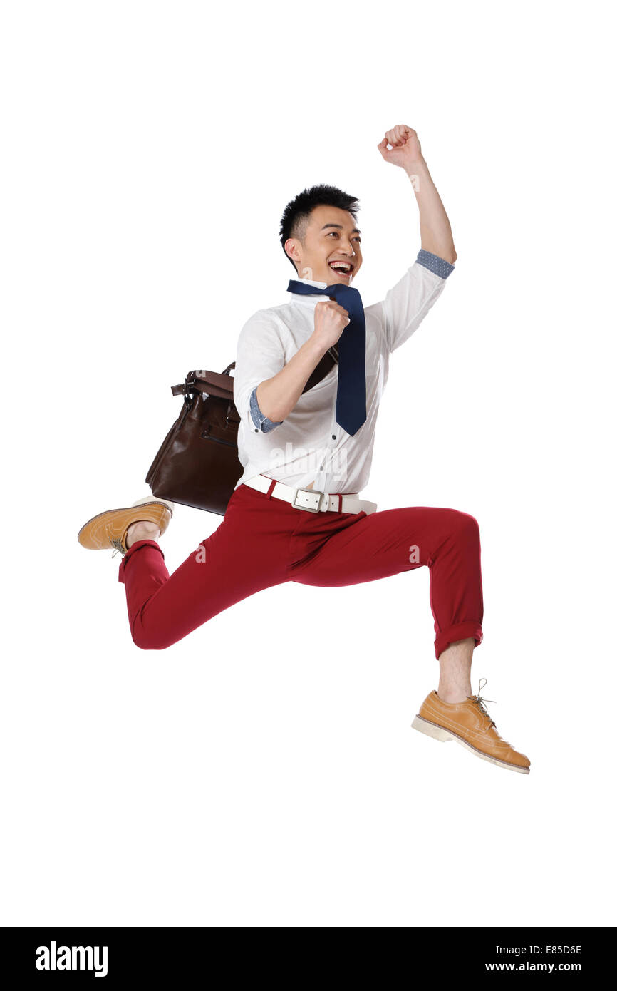 Portrait of young man jumping Stock Photo