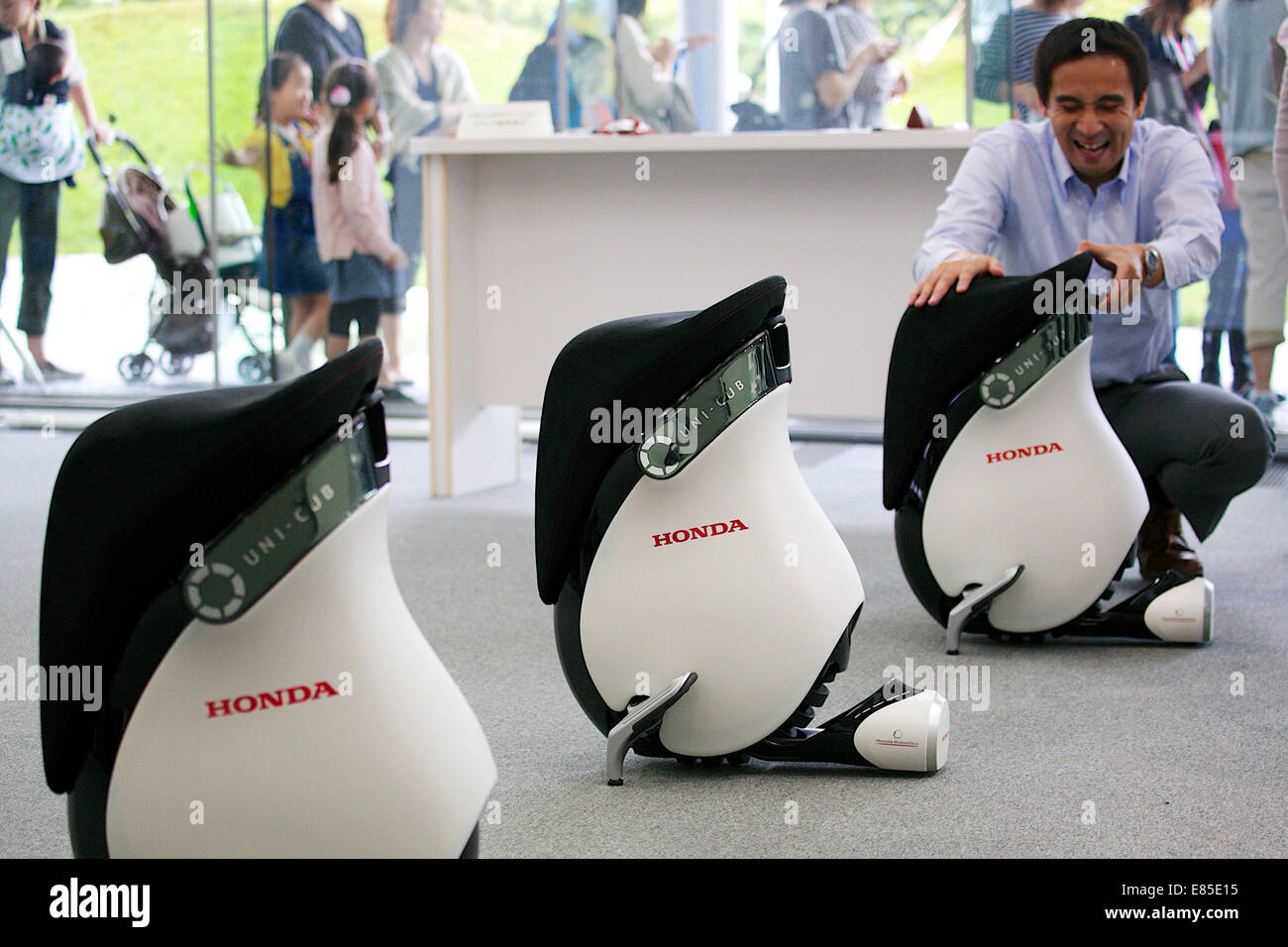 Tokyo, Japan. 1st October, 2014. An exhibitor shows how to ride the Honda's personal mobility device 'UNI-CUB B' at the National Museum of Emerging Science and Innovation (Miraikan) on October 1, 2014 in Tokyo, Japan. For the first time visitors can drive the Honda's personal mobility inside the Miraikan building, the rental cost is 620 JPY (5.66 USD) for adults and 210 JPY (1.92USD) for under 18 years from October 1 to March 31, 2015. According to the Honda staff UNI-CUB B can be used inside the buildings such as museums, airports, universities and other business places. © Rodrigo Reyes Marin Stock Photo