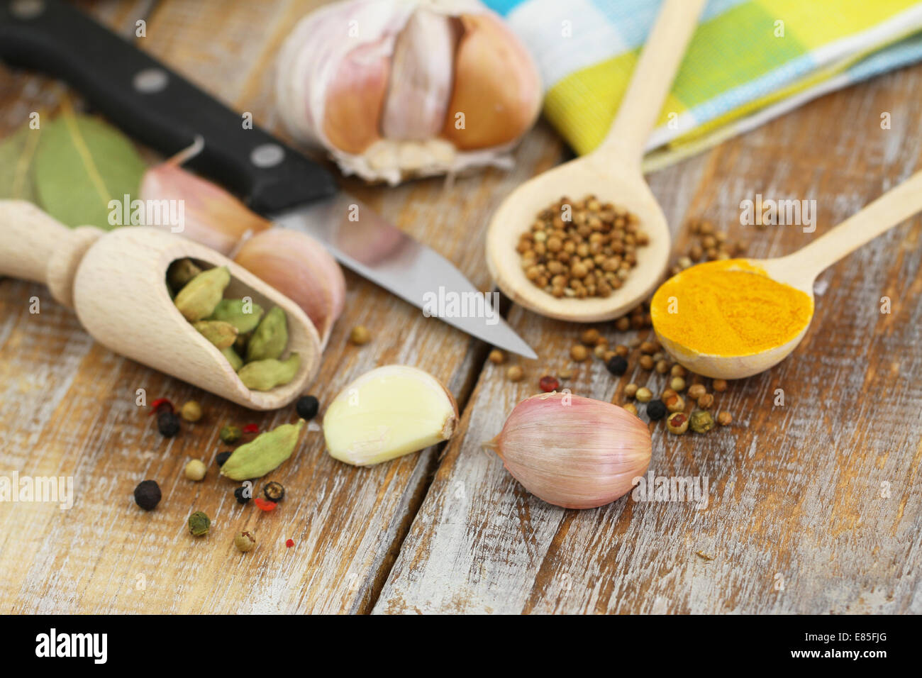 Garlic and other cooking ingredients and spices on wooden surface Stock Photo
