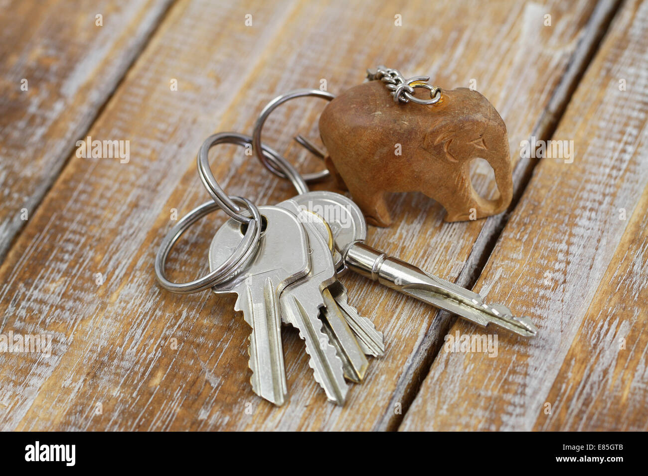 Bunch of keys on chain with little wooden elephant Stock Photo