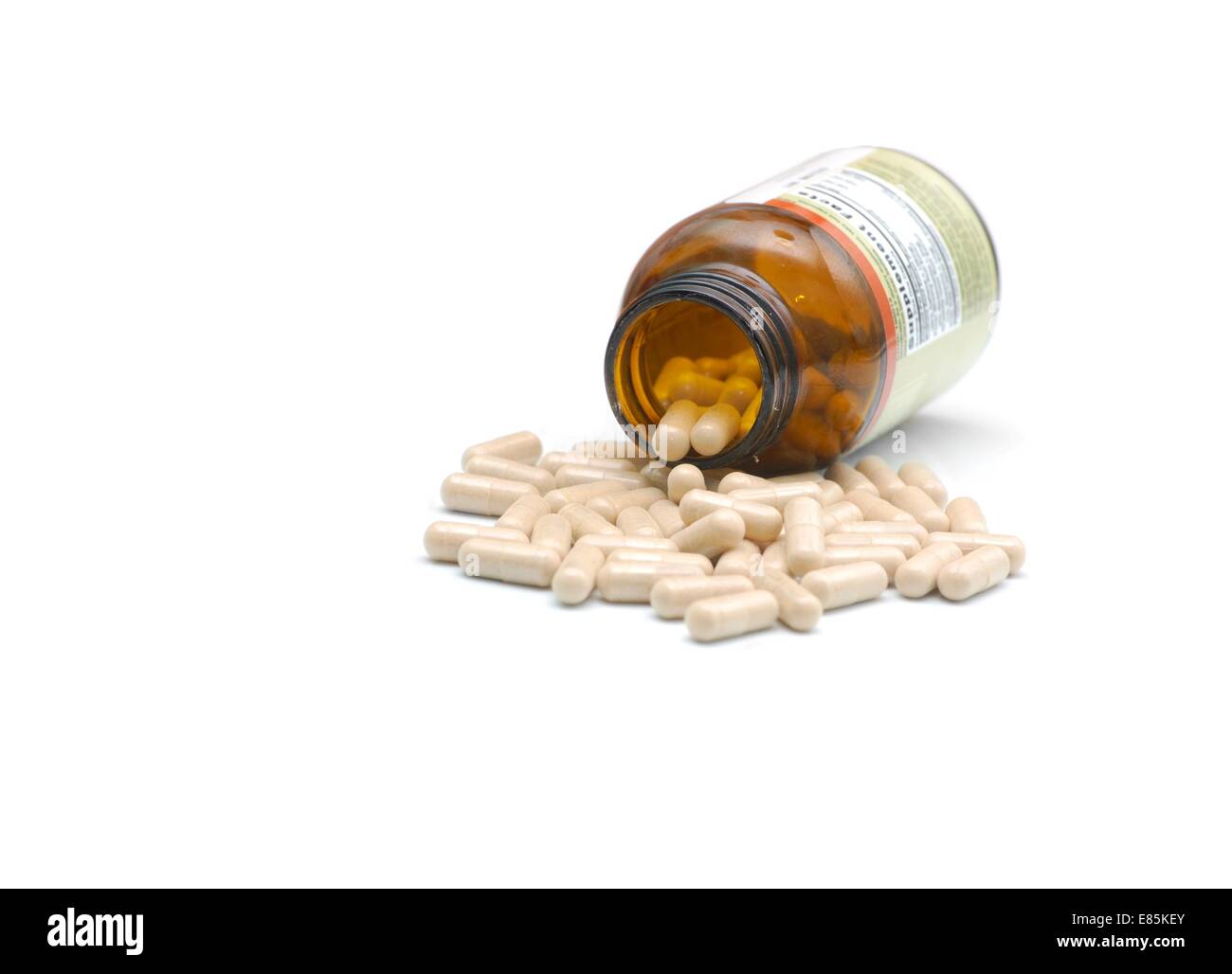 closeup of medical bottle and heap of pills fallen out from Stock Photo