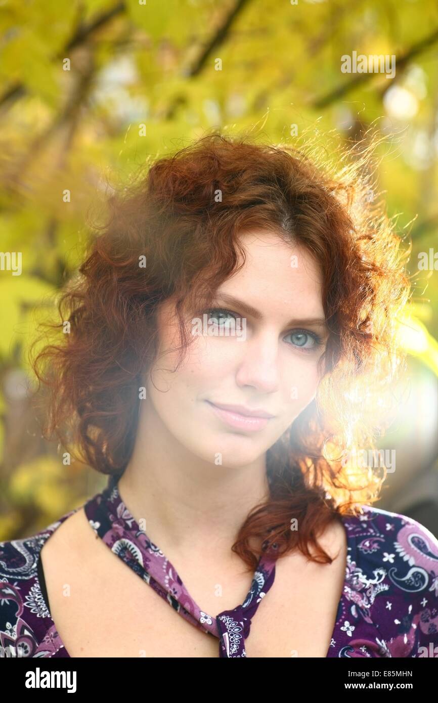 Portrait of a redheaded girl near a tree (autumn colors Stock Photo - Alamy