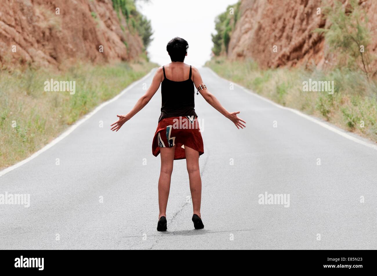 Woman in the middle of the road Stock Photo