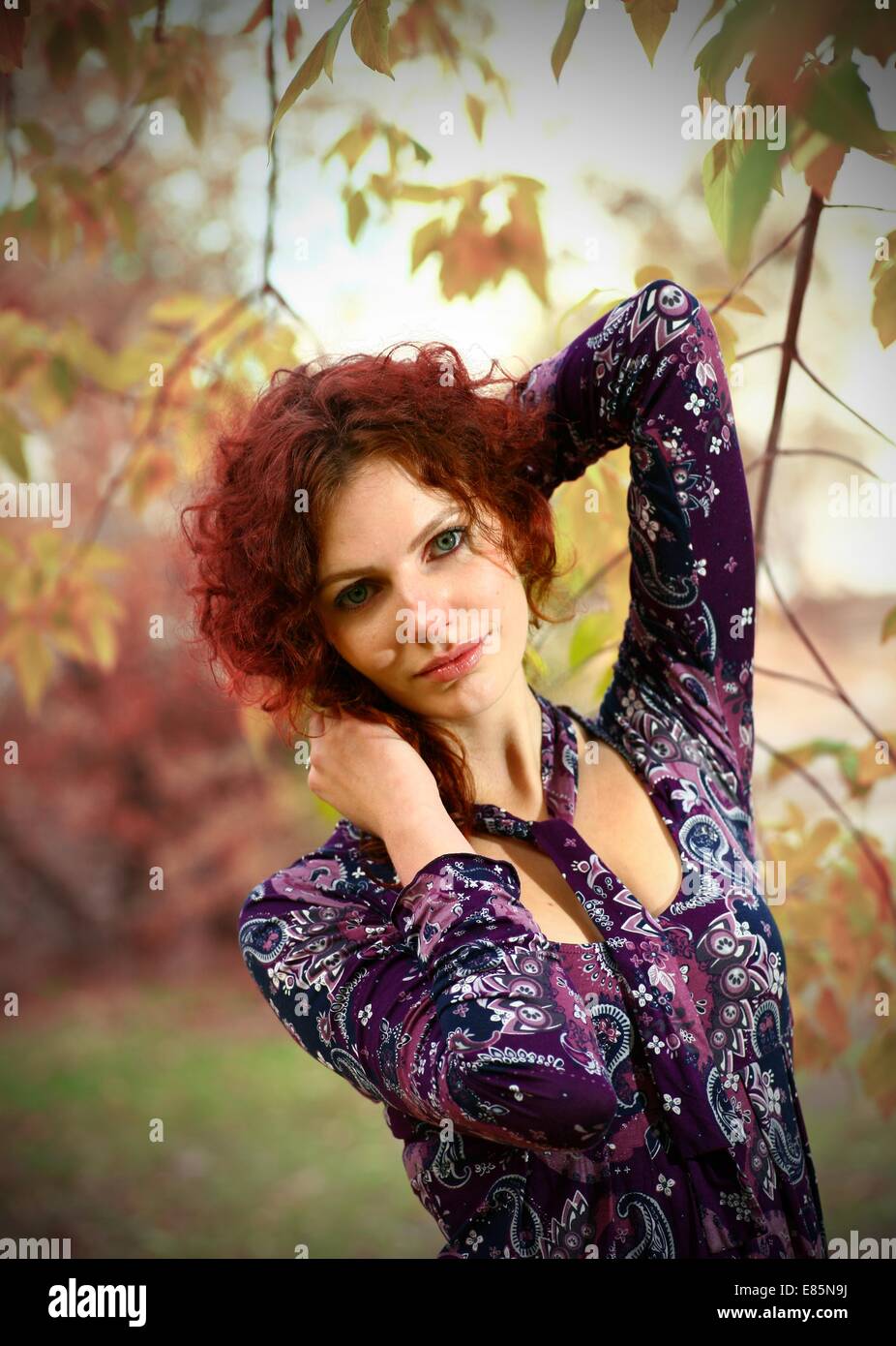 Portrait of a redheaded girl near a tree (split toning Stock Photo - Alamy