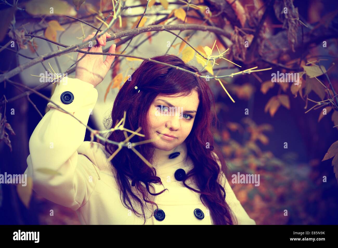 Portrait of a redheaded girl near a tree (split toning Stock Photo - Alamy