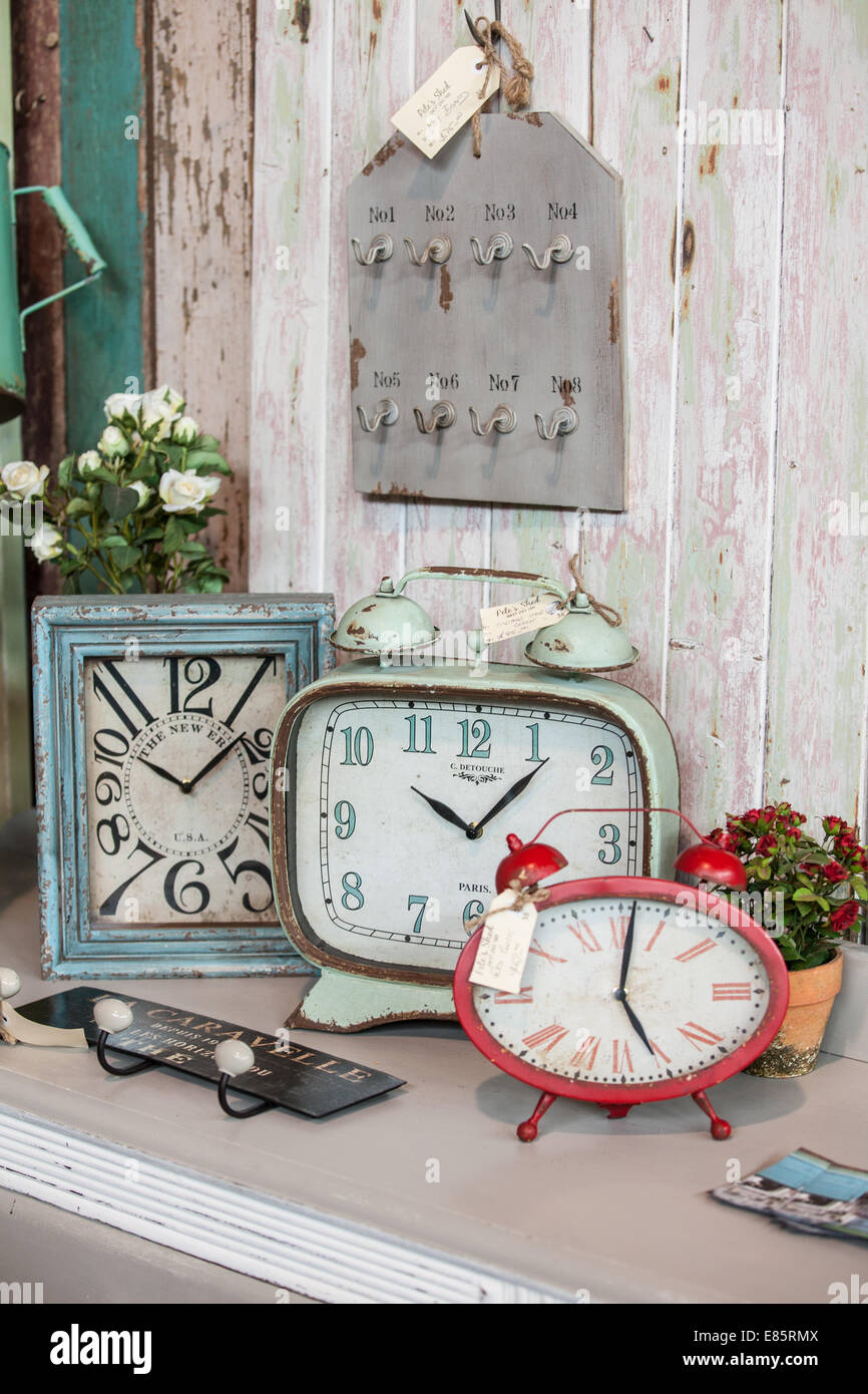 A collection of reproduction antique clocks at a home furnishing store Stock Photo