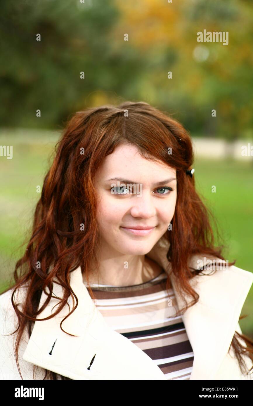 Portrait of a redheaded girl near a tree (autumn colors Stock Photo - Alamy
