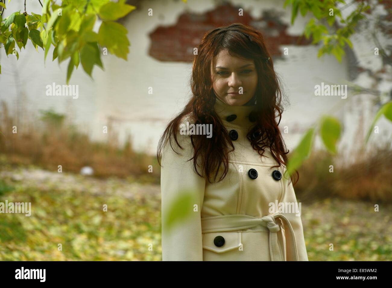 Portrait of a redheaded girl near a tree Stock Photo - Alamy