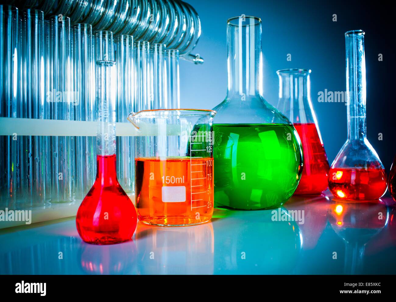 Test tubes on blue background Stock Photo - Alamy