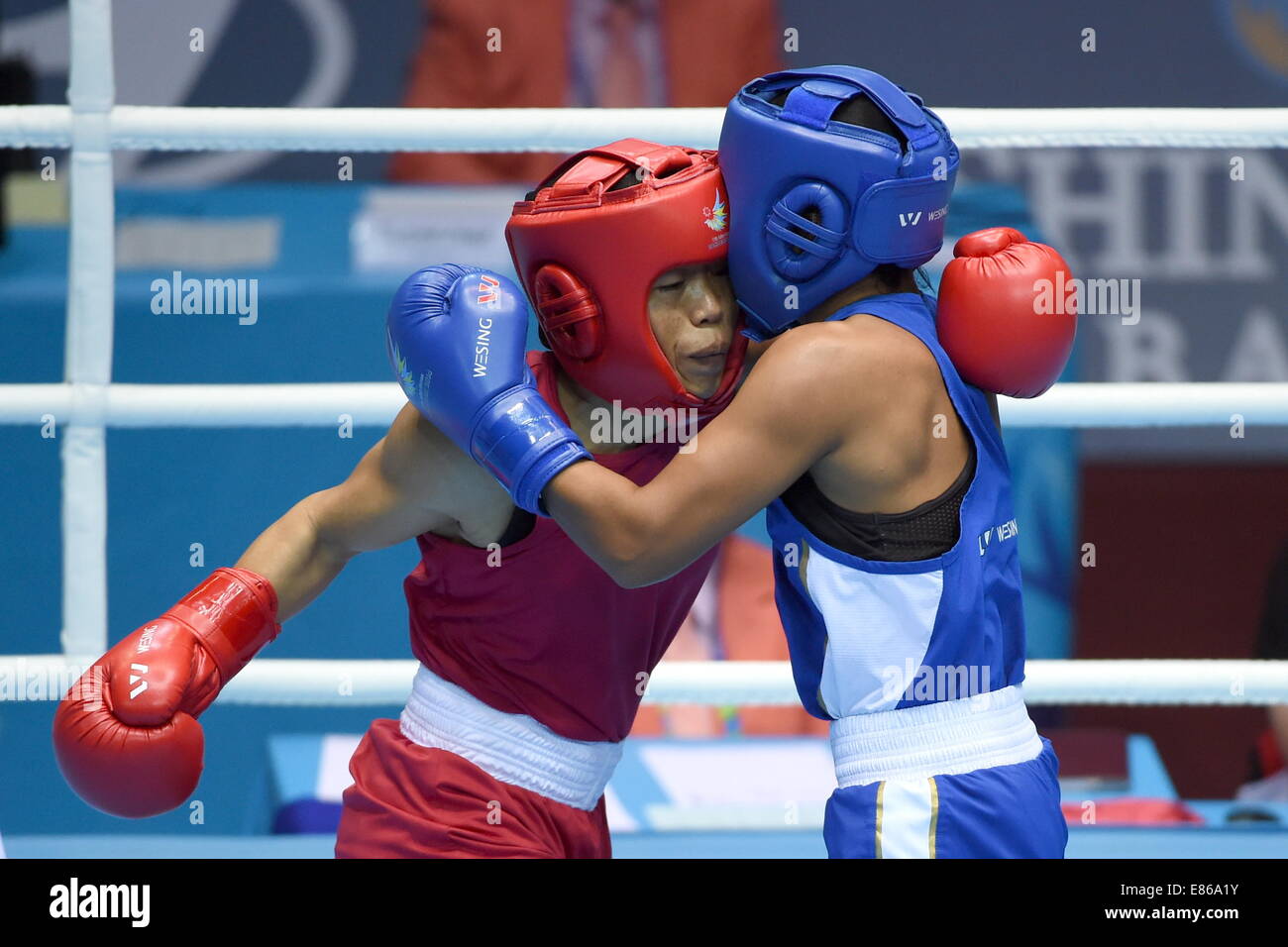 Incheon, South Korea. 1st Oct, 2014. Hmangte Kom (L) of India fights against Shekerbekova Zhaina of Kazakhstan during the women's light 48-51kg final of boxing at the 17th Asian Games in Incheon, South Korea, Oct. 1, 2014. Hmangte Kom won 2-0 and claimed the title. Credit:  Gao Jianjun/Xinhua/Alamy Live News Stock Photo