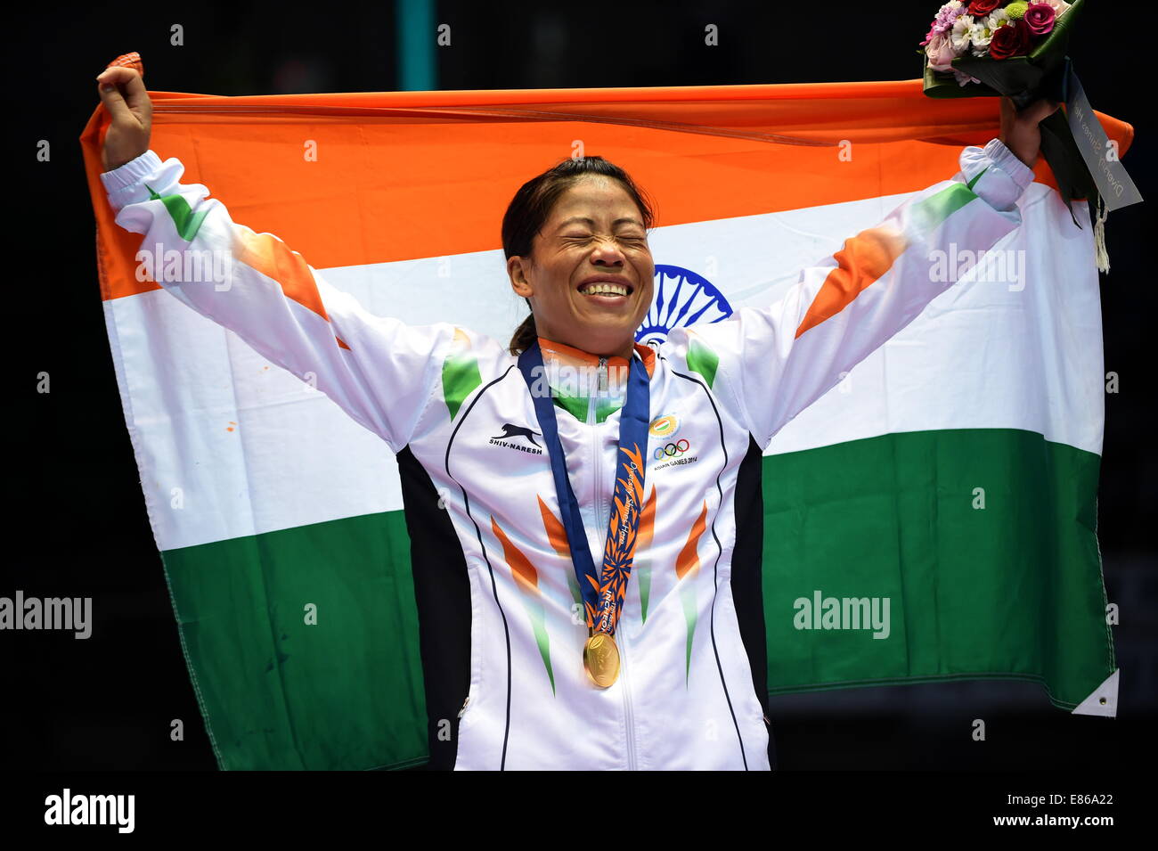 Incheon, South Korea. 1st Oct, 2014. Gold medalist Hmangte Kom of India poses on the podium during the awarding ceremony of the women's light 48-51kg contest of boxing at the 17th Asian Games in Incheon, South Korea, Oct. 1, 2014. Credit:  Gao Jianjun/Xinhua/Alamy Live News Stock Photo