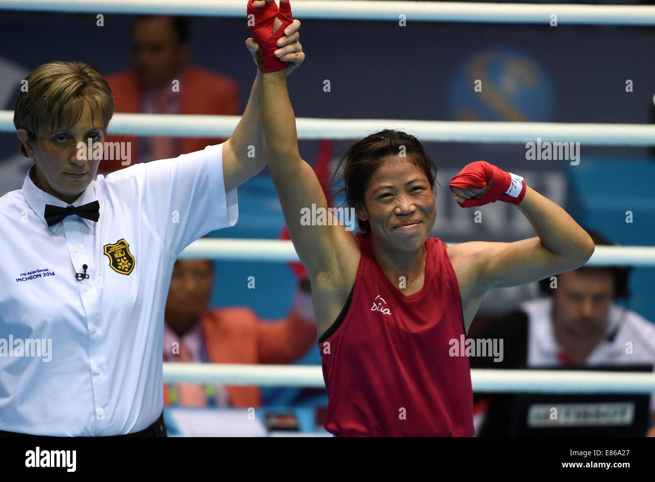 Incheon, South Korea. 1st Oct, 2014. Hmangte Kom (R) of India is announced the winner of the women's light 48-51kg contest of boxing at the 17th Asian Games in Incheon, South Korea, Oct. 1, 2014. Hmangte Kom defeated Shekerbekova Zhaina of Kazakhstan 2-0 and claimed the title. Credit:  Gao Jianjun/Xinhua/Alamy Live News Stock Photo