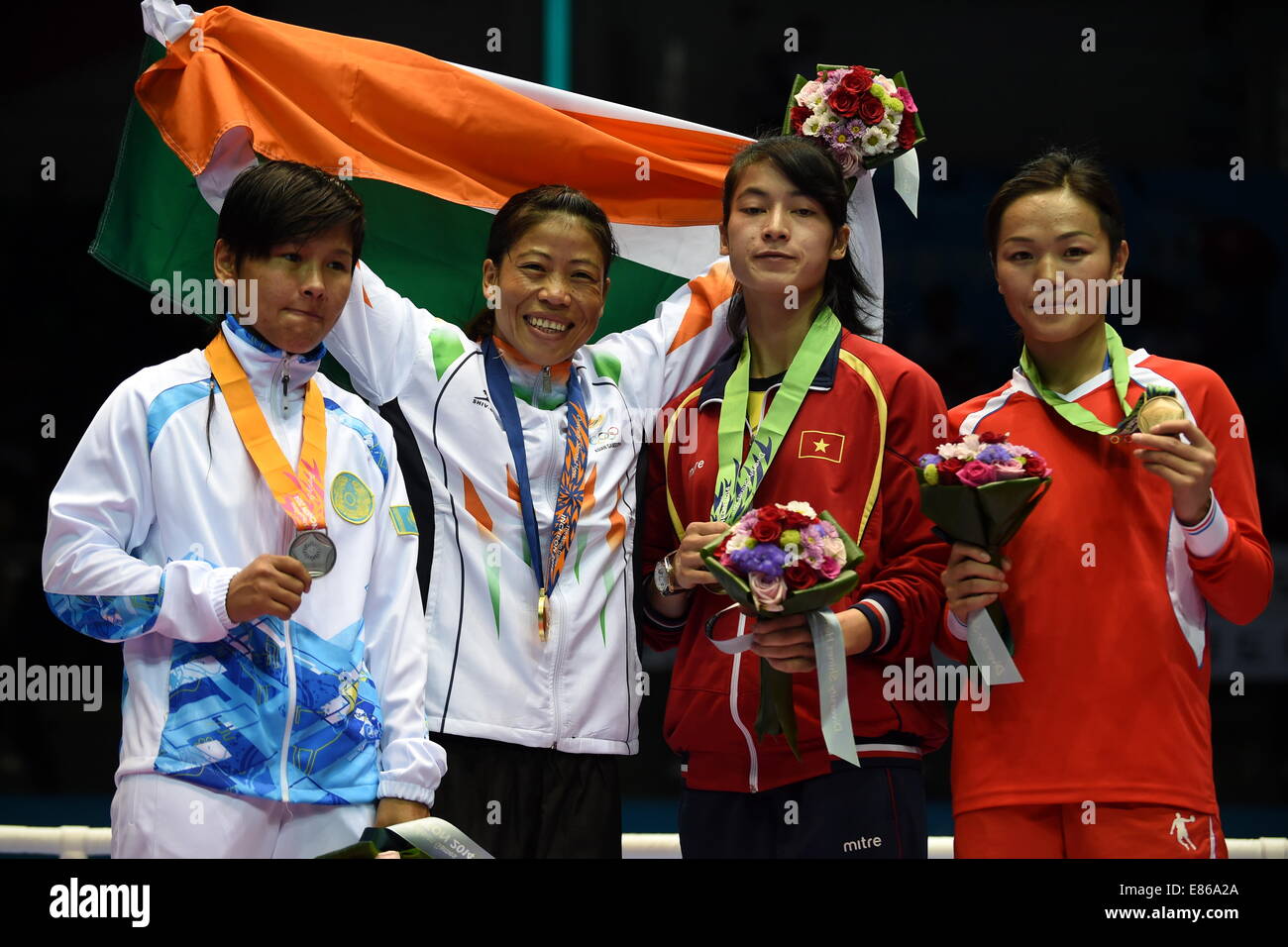 Incheon, South Korea. 1st Oct, 2014. Gold medalist Hmangte Kom (2nd L) of India, silver medalist Shekerbekova Zhaina of Kazakhstan (1st L) and bronze medalists Le Thai Bang (2nd R) of Vietnam and Myagmardulam Nandintsetseg of Mongolia pose during the awarding ceremony of the women's light 48-51kg contest of boxing at the 17th Asian Games in Incheon, South Korea, Oct. 1, 2014. Credit:  Gao Jianjun/Xinhua/Alamy Live News Stock Photo