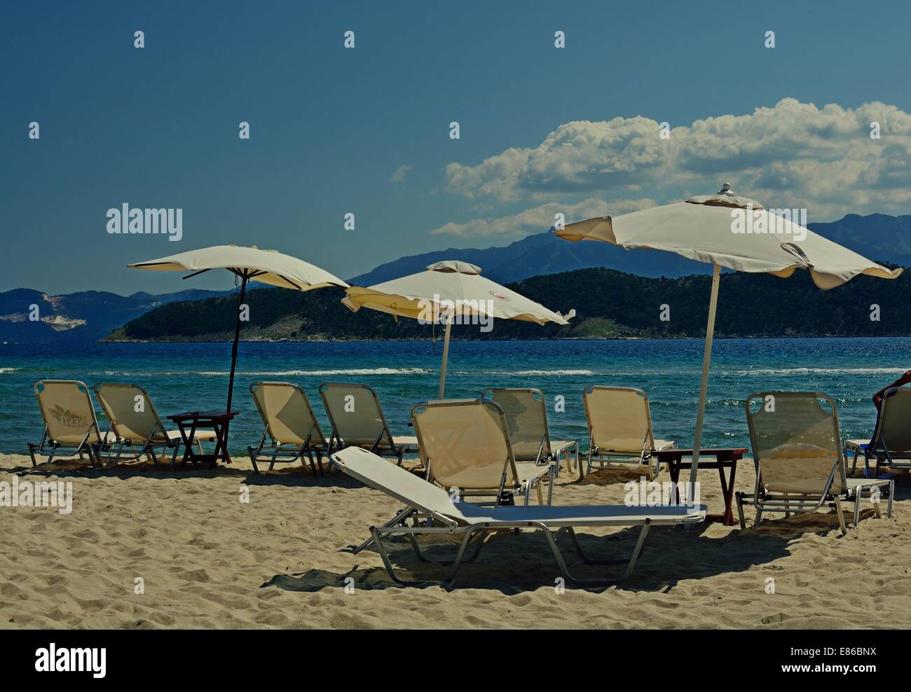 Lounges and umbrellas on Keramoti Beach,Greece Stock Photo