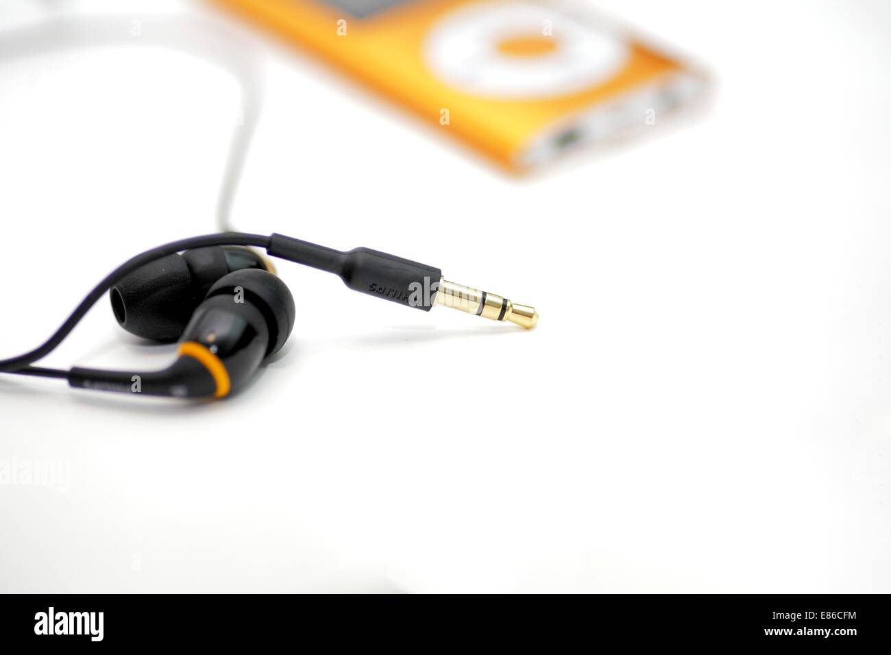 MP3 player and earphones isolated on white background low angle Stock ...