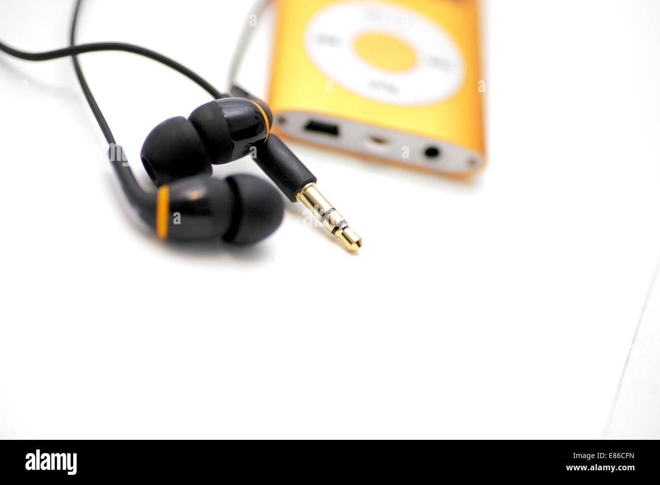 MP3 player and earphones isolated on white background low angle Stock ...