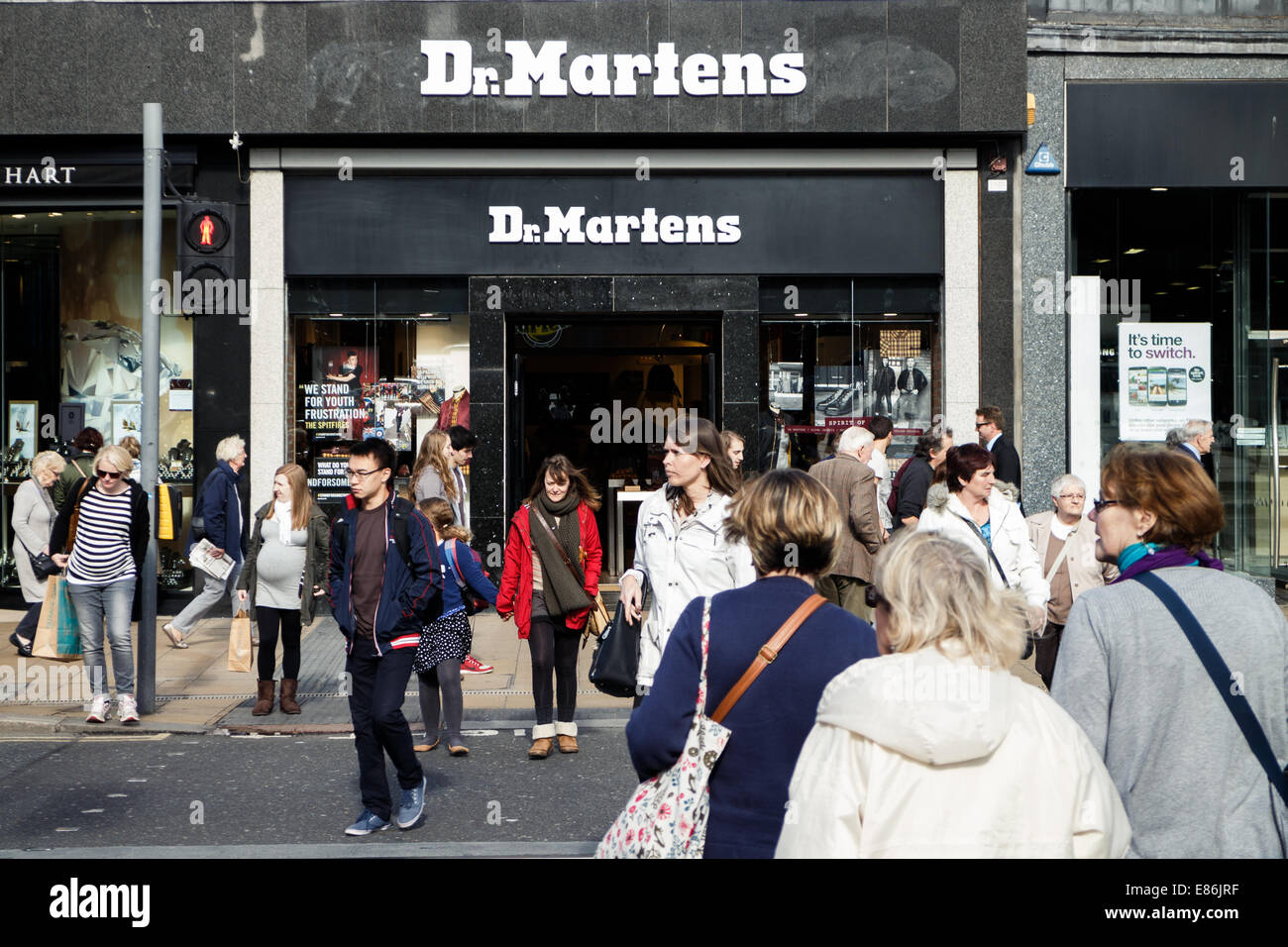 Shoppers crossing Princes Street in front of the Dr Martens store, Edinburgh, Scotland. Stock Photo