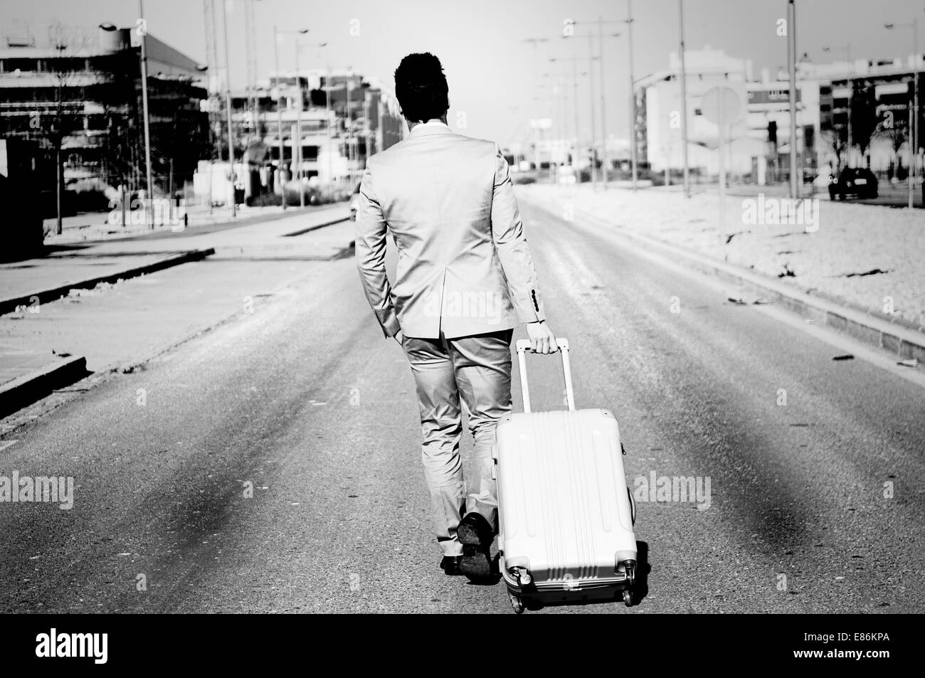 Man dressed in suit and suitcase in the street Stock Photo Alamy