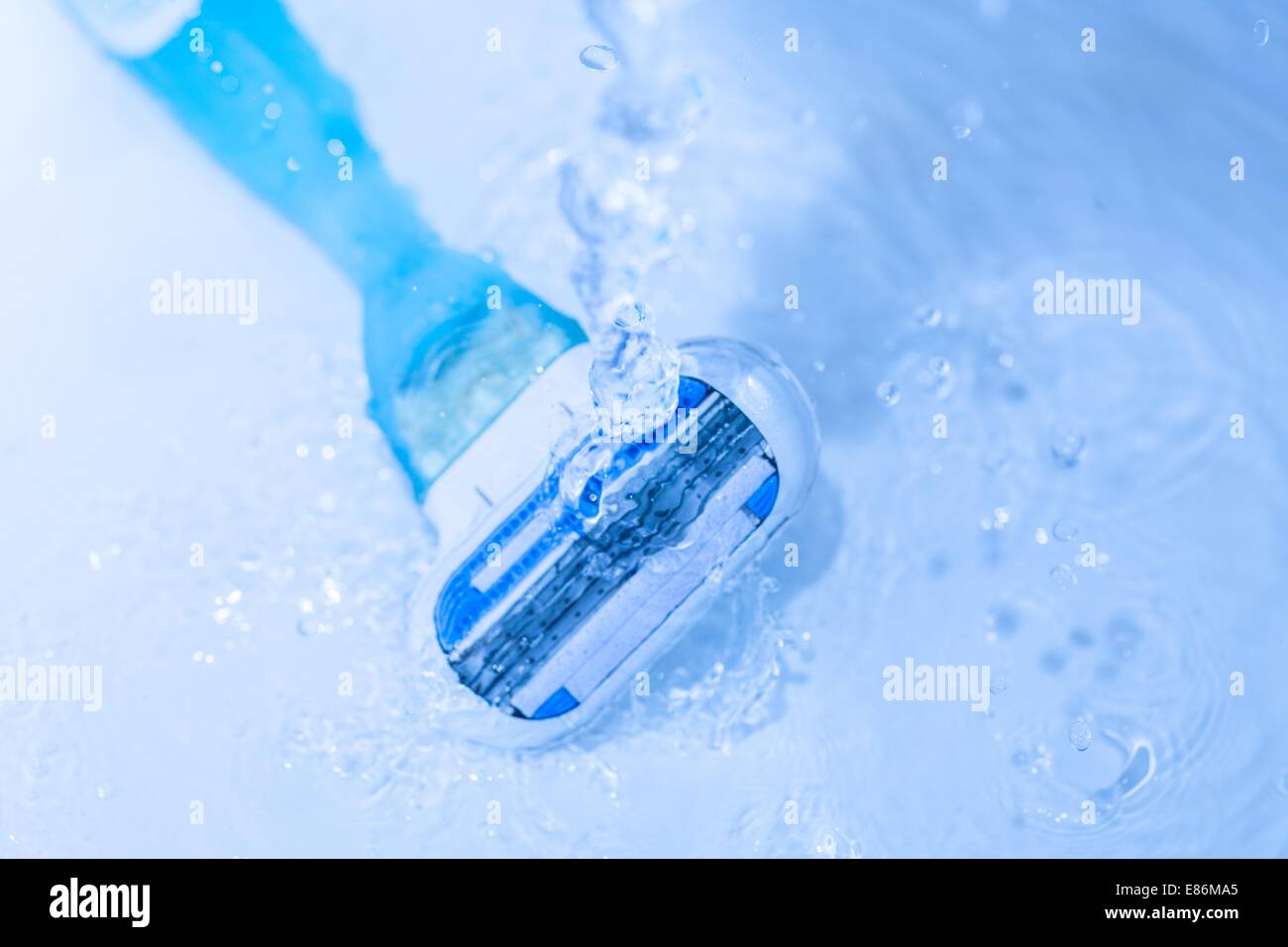 razor close-up with water splash isolated on grey Stock Photo - Alamy