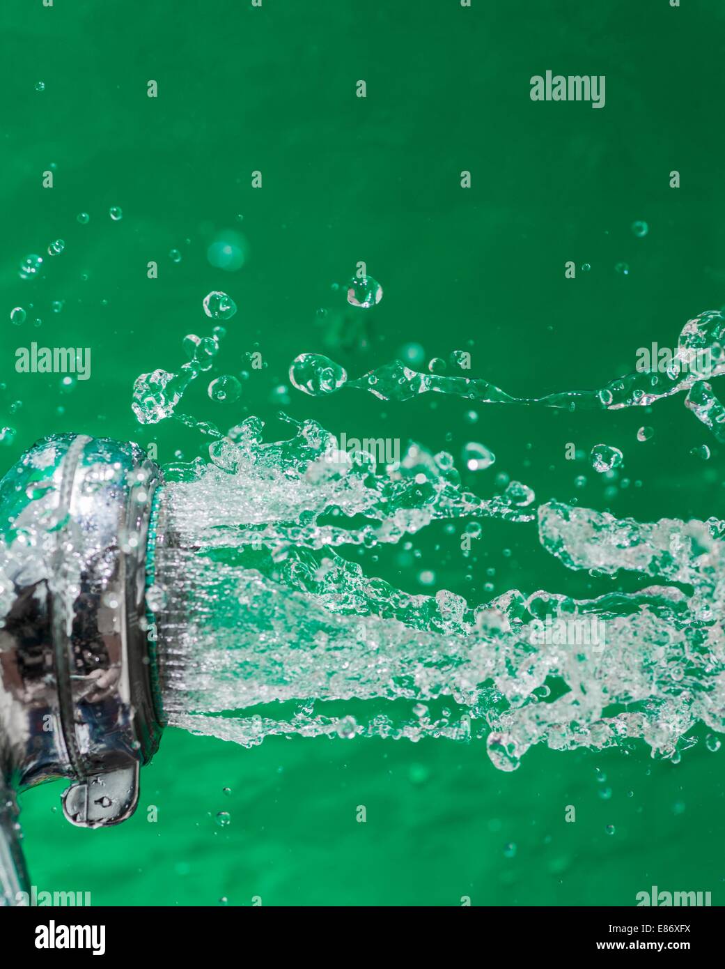 Shower with falling drops of water on the green background Stock Photo ...