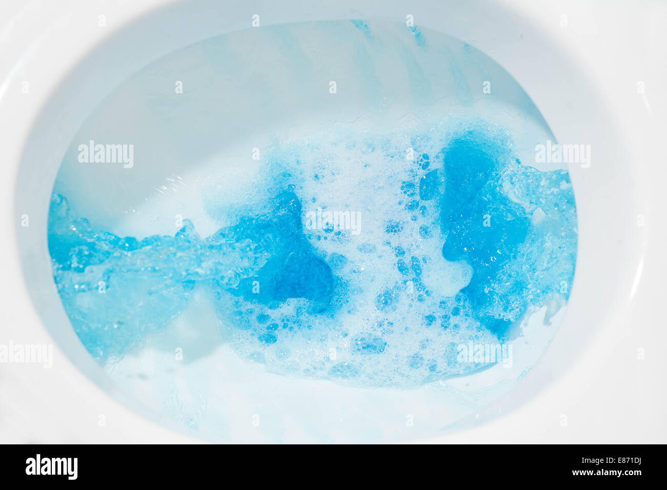Blue water flow. Toilet bowl closeup with blue water Stock Photo Alamy