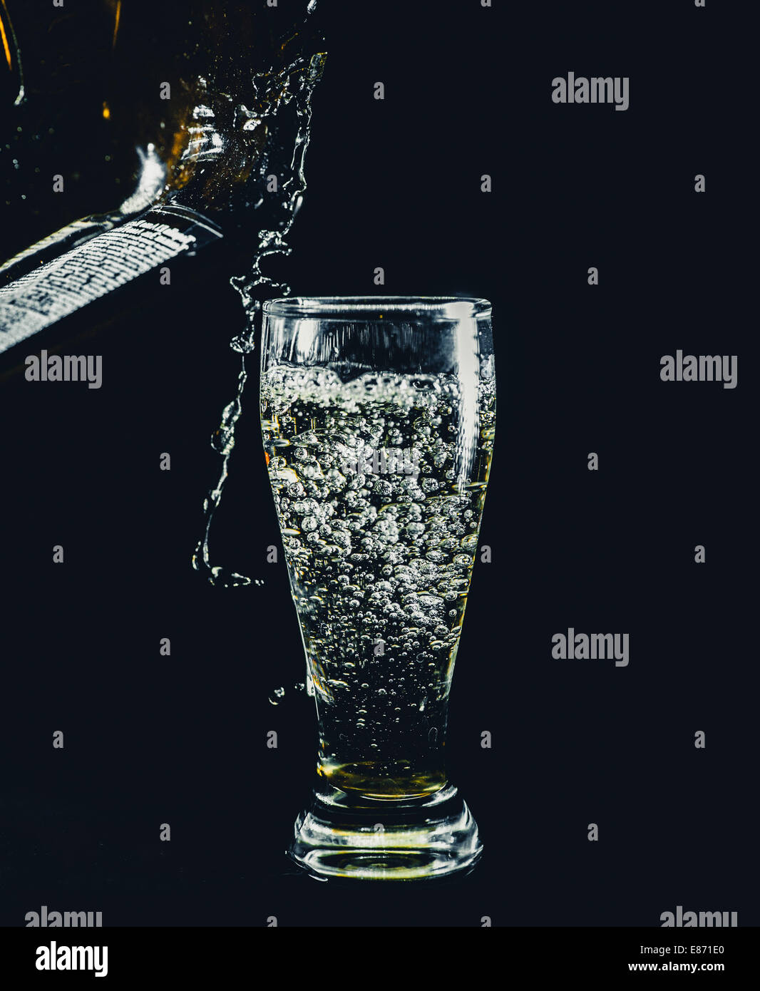 pouring drink in shot glass on black Stock Photo - Alamy