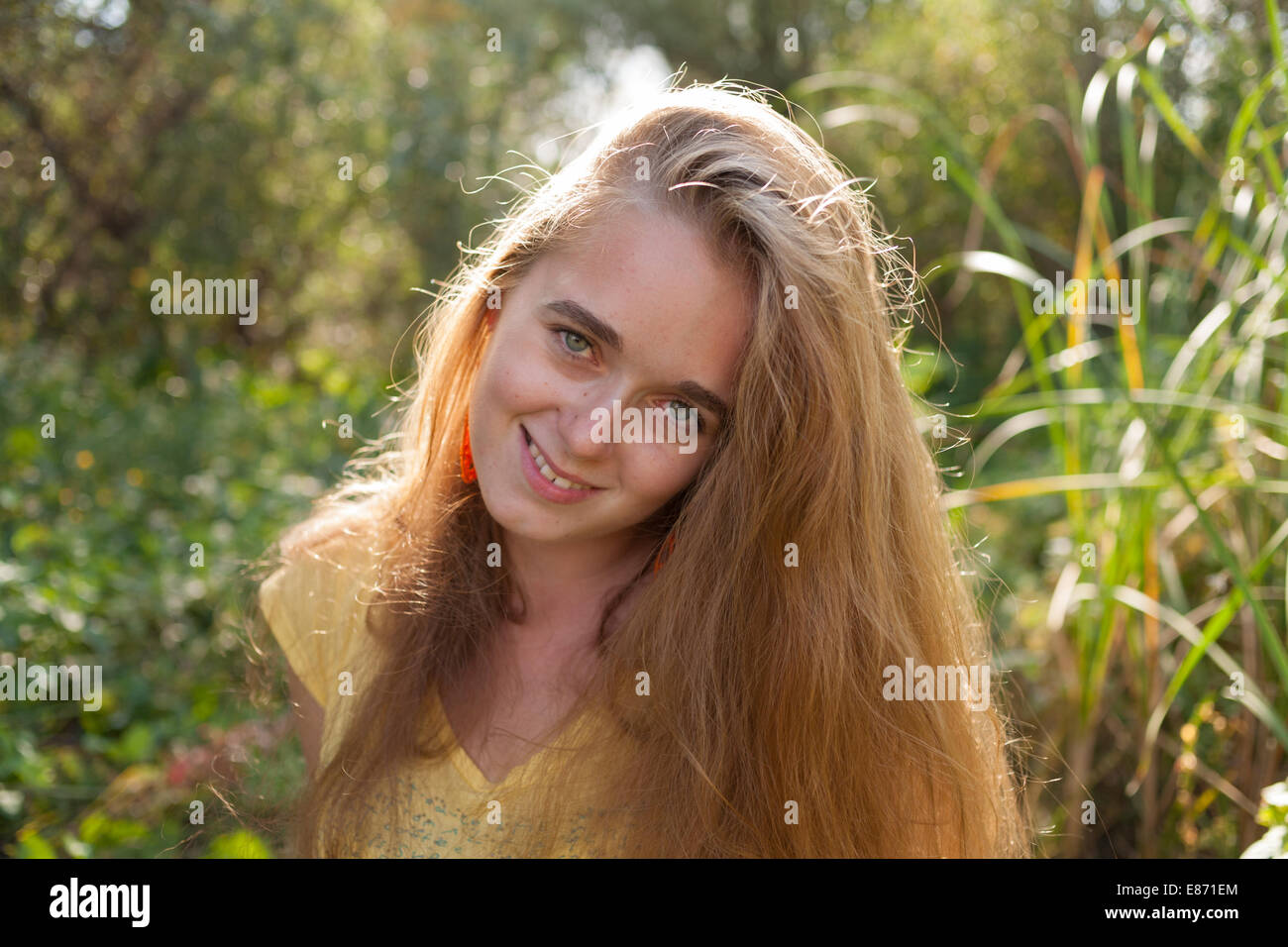 Young female outside enjoying warm wether. Happy woman outdoors. Stock Photo